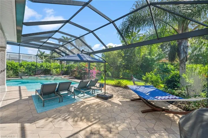 View of patio with area for grilling and a lanai