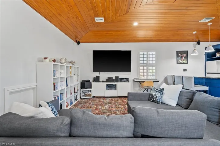 Living room with lofted ceiling and wooden ceiling