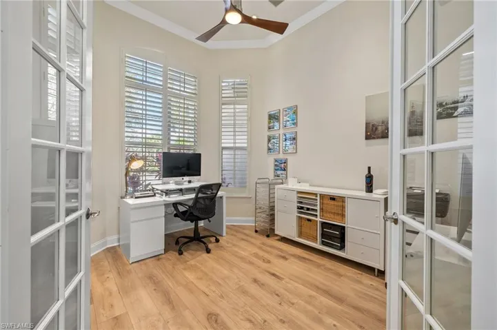 Office with french doors, ceiling fan, crown molding, and light wood-type flooring