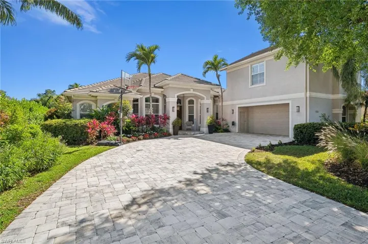 Mediterranean / spanish home featuring stucco siding, a tiled roof, decorative driveway, and a garage