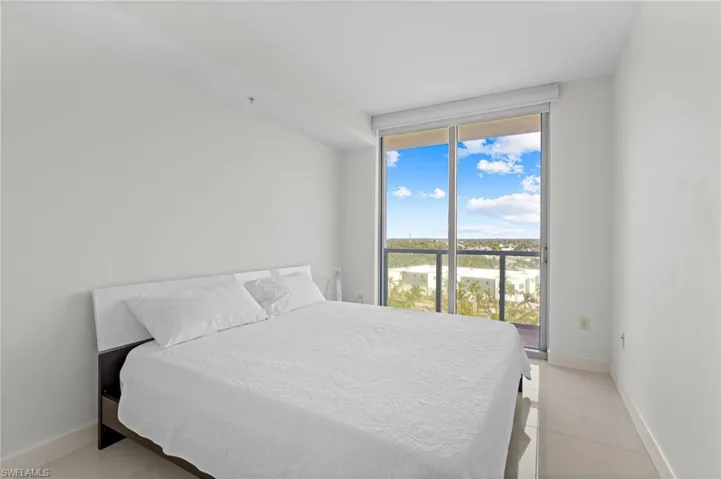 Bedroom with baseboards and access to outside