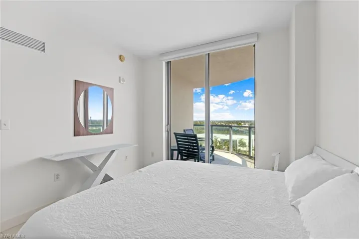 Bedroom featuring access to outside and baseboards