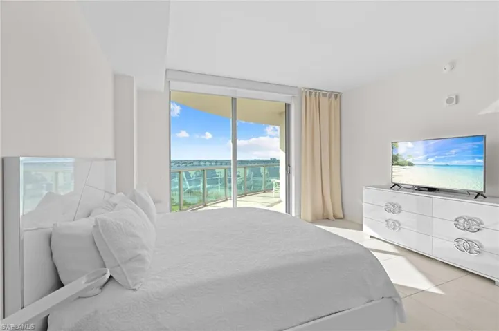 Bedroom featuring floor to ceiling windows, access to exterior, and light tile patterned flooring