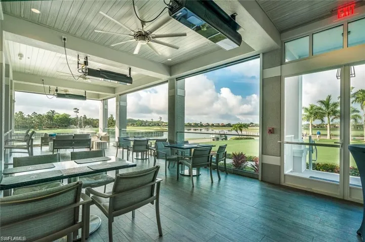 Sunroom / solarium with hardwood / wood-style floors, healthy amount of natural light, wood ceiling, and a water view