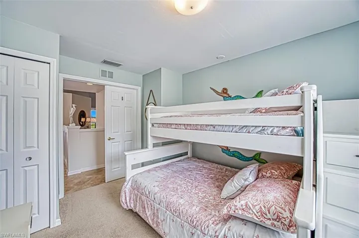 Bedroom featuring a closet and light colored carpet