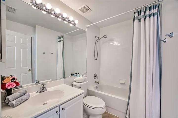 Full bath featuring shower / tub combo and vanity