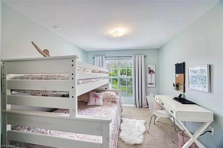 Bedroom featuring light colored carpet