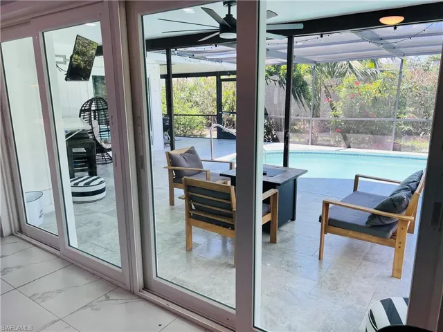 Entryway featuring a sunroom and a ceiling fan