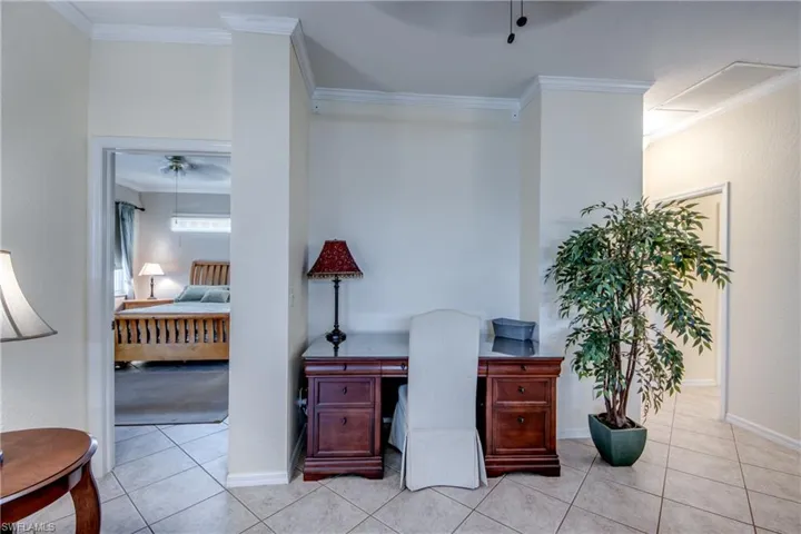 Ceramic tile flooring, crown molding, and recessed wall niche