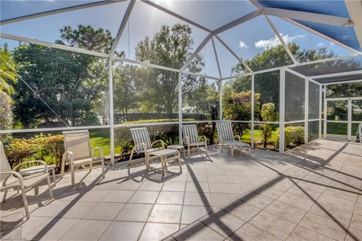 Screen-enclosed patio featuring ceramic tile flooring, metal frame structure, and direct outdoor access