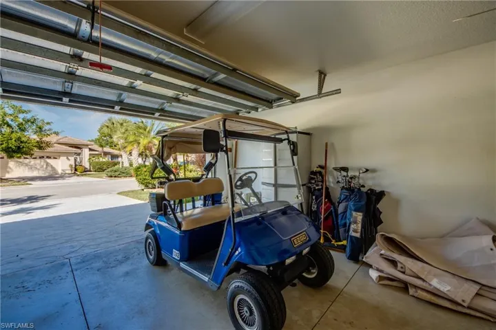 Enclosed garage featuring concrete flooring and a mounted overhead door track system