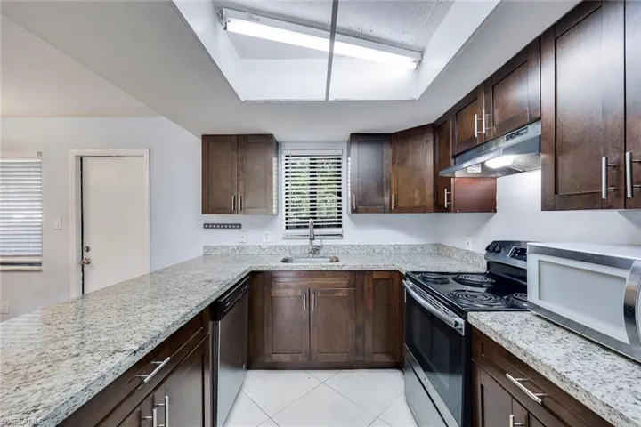 Kitchen features granite countertops and stainless steel appliances.