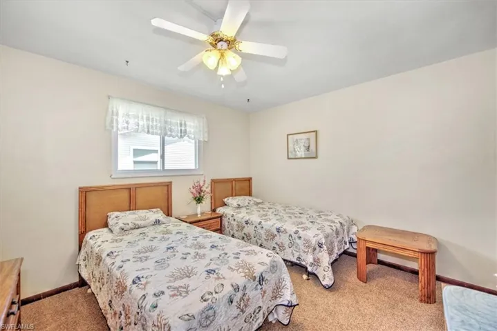 Bedroom with light colored carpet and ceiling fan