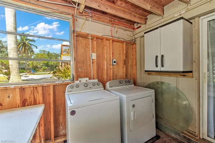 Laundry room featuring cabinets and washing machine and clothes dryer