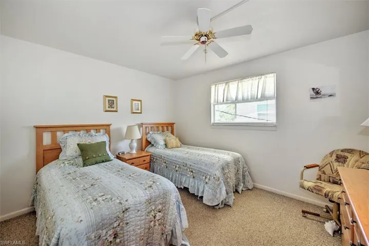 Bedroom featuring ceiling fan and carpet