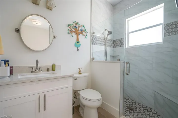 Full bathroom with a stall shower and vanity