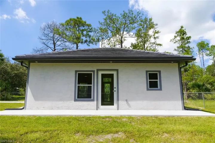 Back of property featuring stucco siding