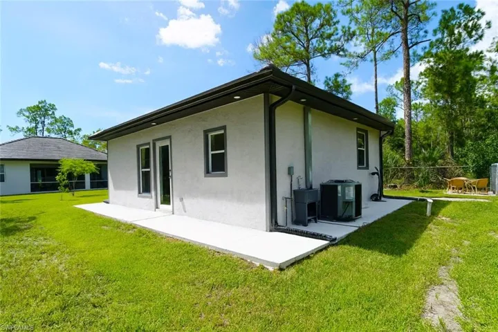 Rear view of house with a patio and stucco siding