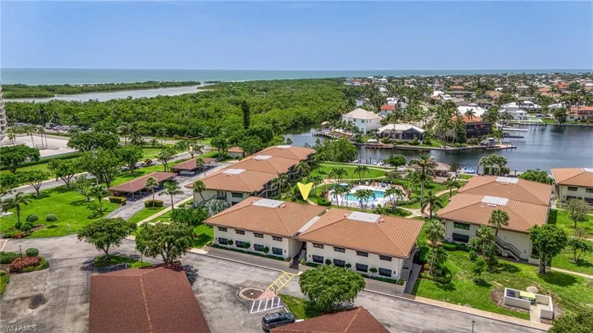 Aerial perspective of suburban area featuring a large body of water
