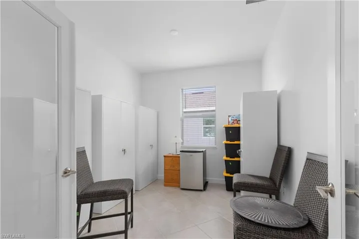 Sitting room with light tile patterned flooring
