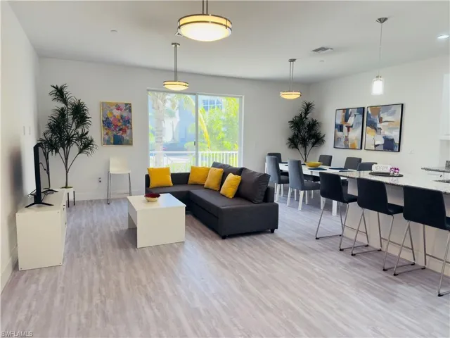 Living room with light wood-type flooring and baseboards