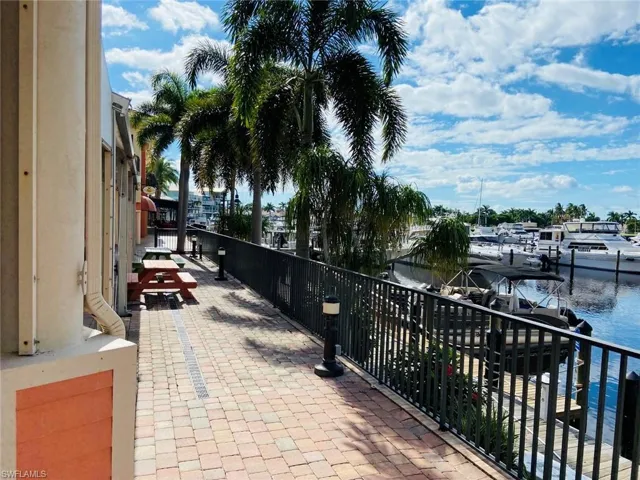 View of patio / terrace with a water view and a boat dock