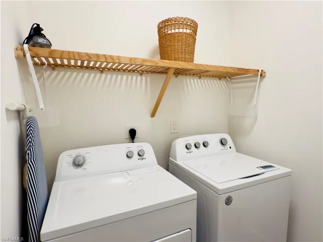 Laundry area with washing machine and clothes dryer