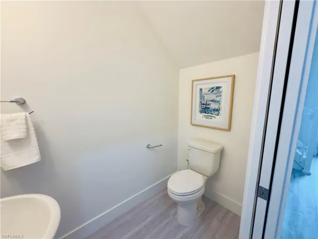 Bathroom with baseboards and wood finished floors