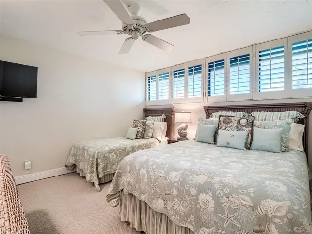 Guest bedroom featuring ceiling fan and carpet flooring