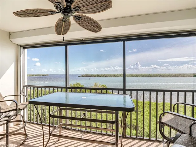 Screened in balcony overlooking views of the back bay and ceiling fan for extra breeze