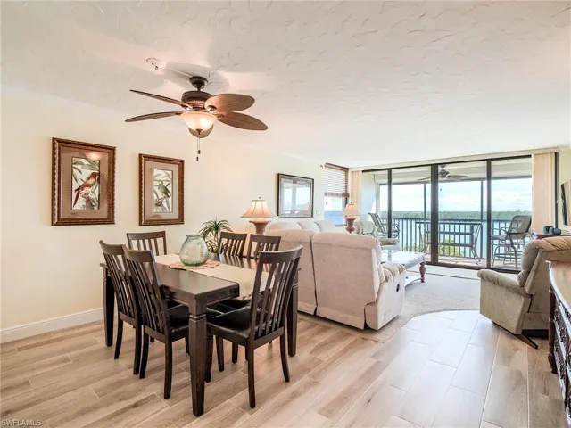 Dining space with new table & chairs in 2023, ornamental molding, ceiling fan, and porcelain tile flooring installed in 2022