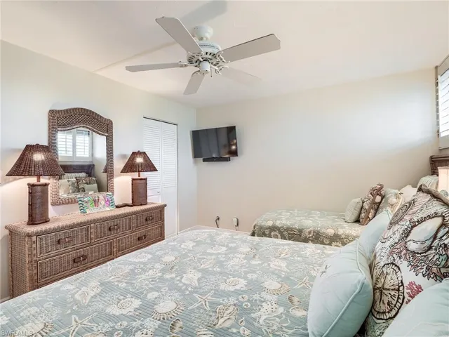 Guest bedroom with a walk in  closet and ceiling fan