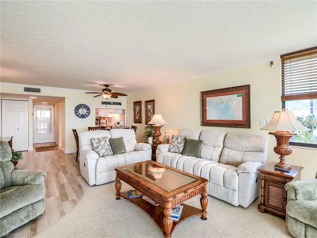 Living room featuring carpeted floor and reclining chairs for comfort