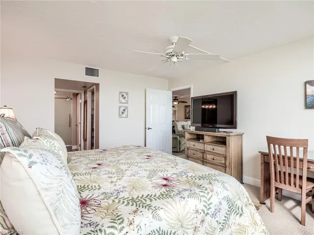 Master Bedroom featuring light colored carpet, ceiling fan and work desk