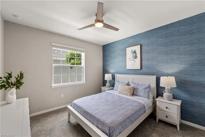 Bedroom with ceiling fan and carpet flooring