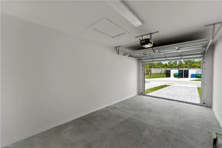 Garage featuring a garage door opener