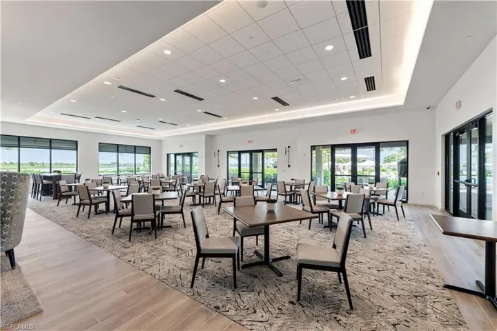 Dining room featuring a drop ceiling, french doors, light wood-type flooring, and a tray ceiling