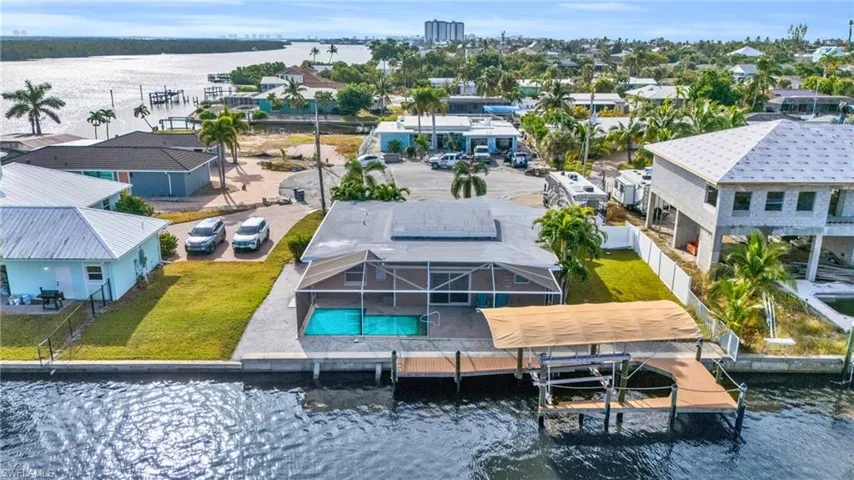 Birds eye view of property with a water view