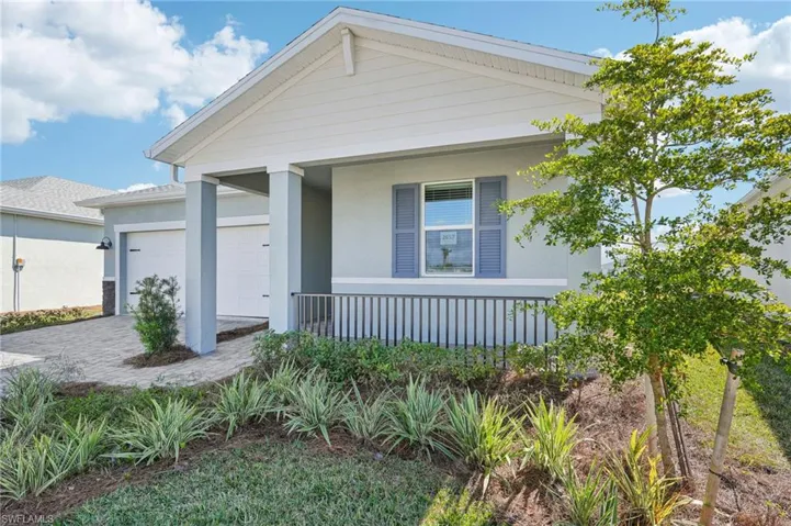 View of front of house featuring a garage and covered porch