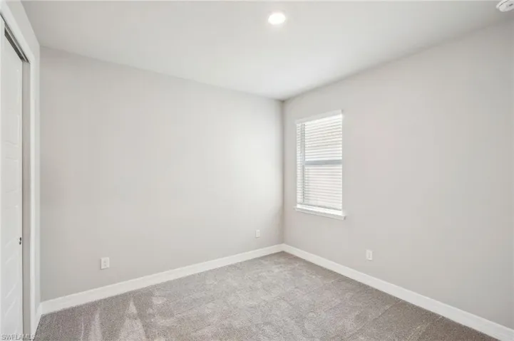 Empty room with carpet floors