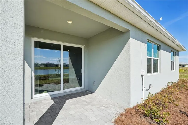 View of exterior entry featuring a patio