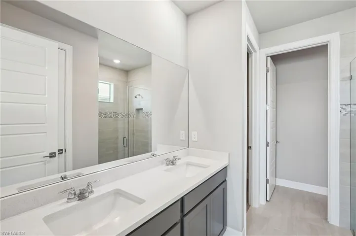 Bathroom featuring vanity and a shower with shower door