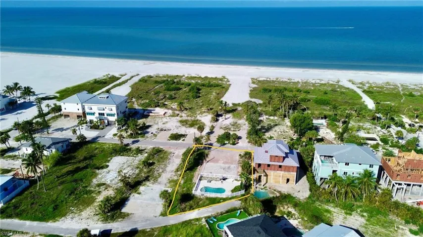 Bird's eye view with a water view and pool