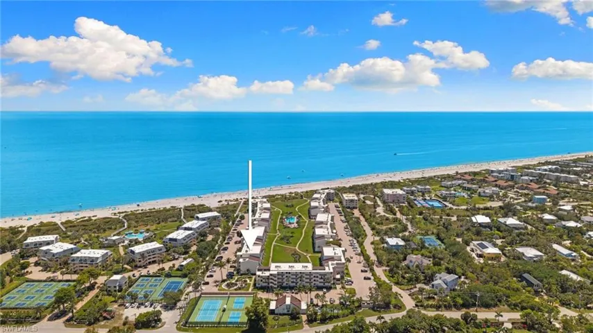 Aerial view of residential area featuring unending shoreline
