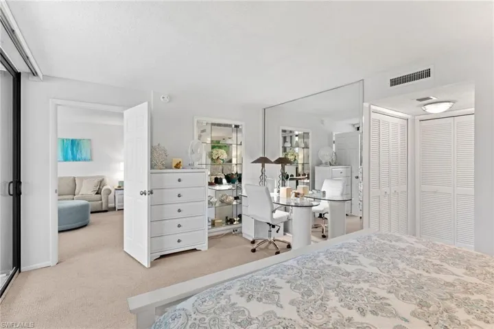Primary Bedroom featuring a closet, light colored carpet, and a textured ceiling