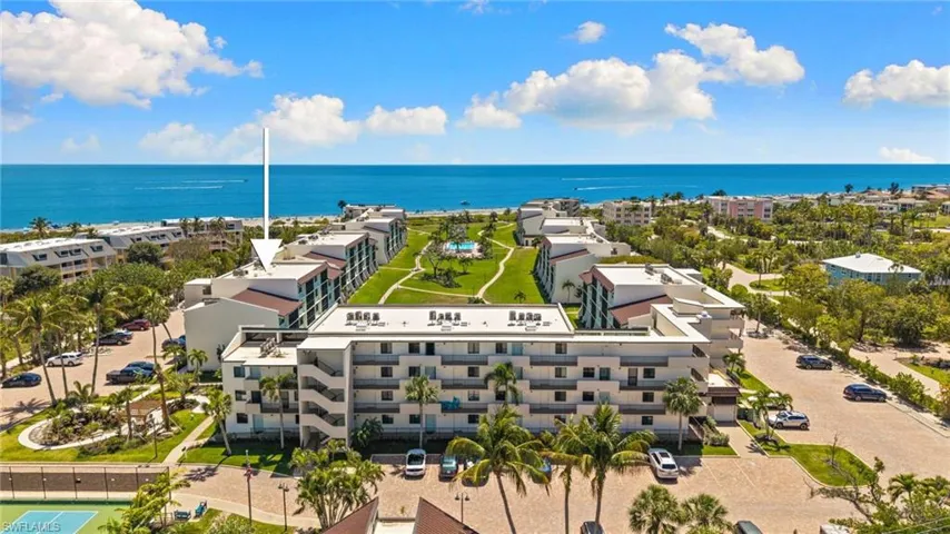 Aerial view of a nearby body of water and apartment complex / building