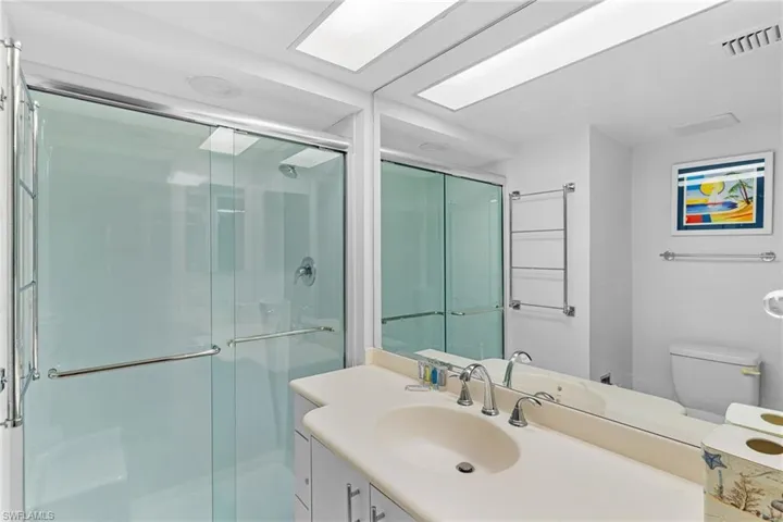 Full bathroom featuring vanity and a shower stall