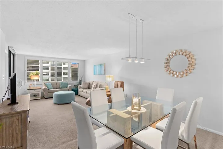 Carpeted dining area with a textured ceiling