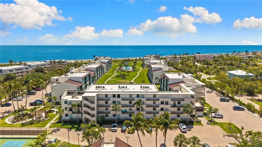 Aerial view of a nearby body of water and apartment complex / building