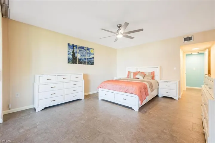 Bedroom with ceiling fan and baseboards